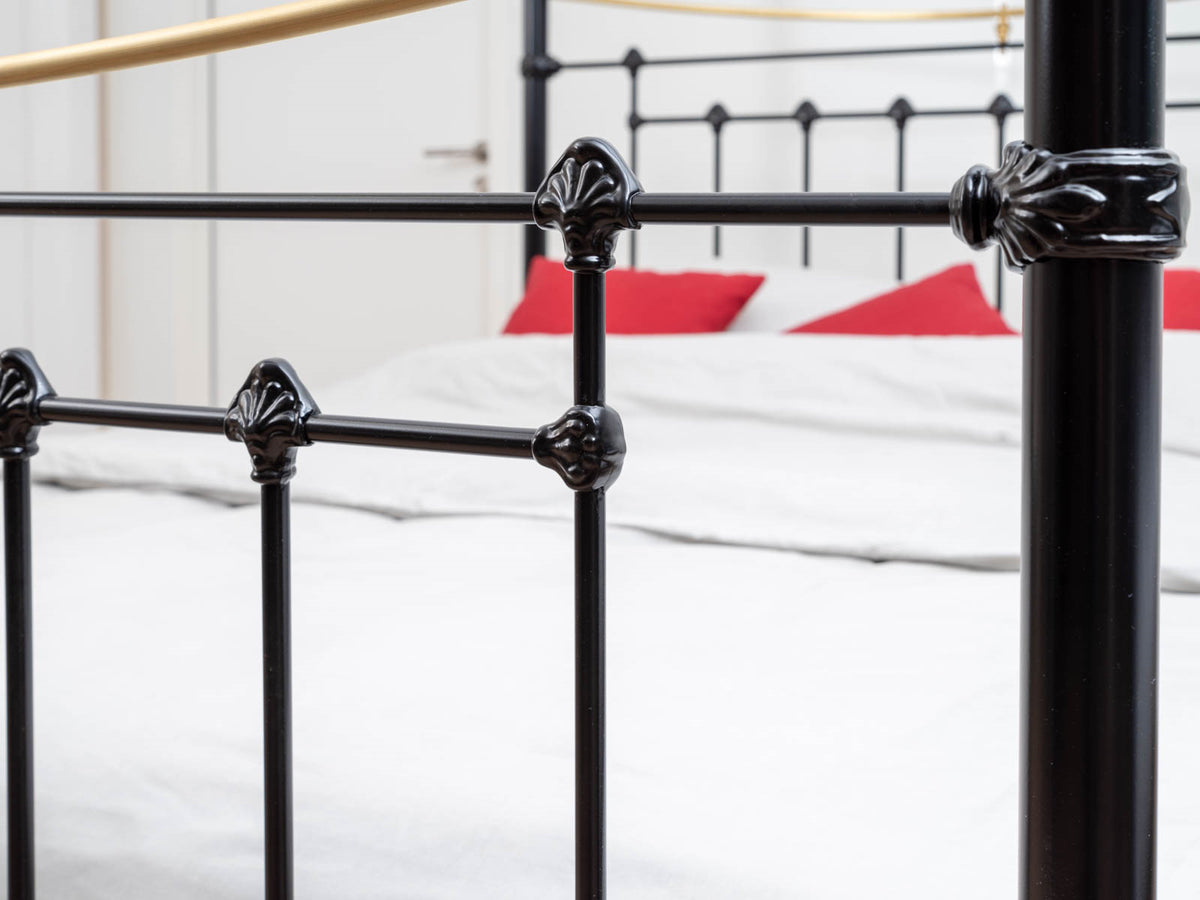 Detail of the black cast decorative knobs on the spindles and post of the Durham canopy bed showroom model 180x200cm