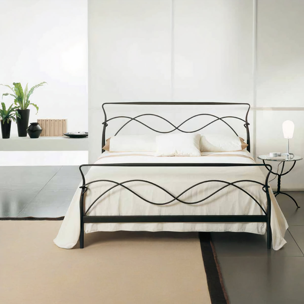 Girona showroom model 180×200 metal bed in black with wavy crossed rails in the headboard and footboard, in a white room