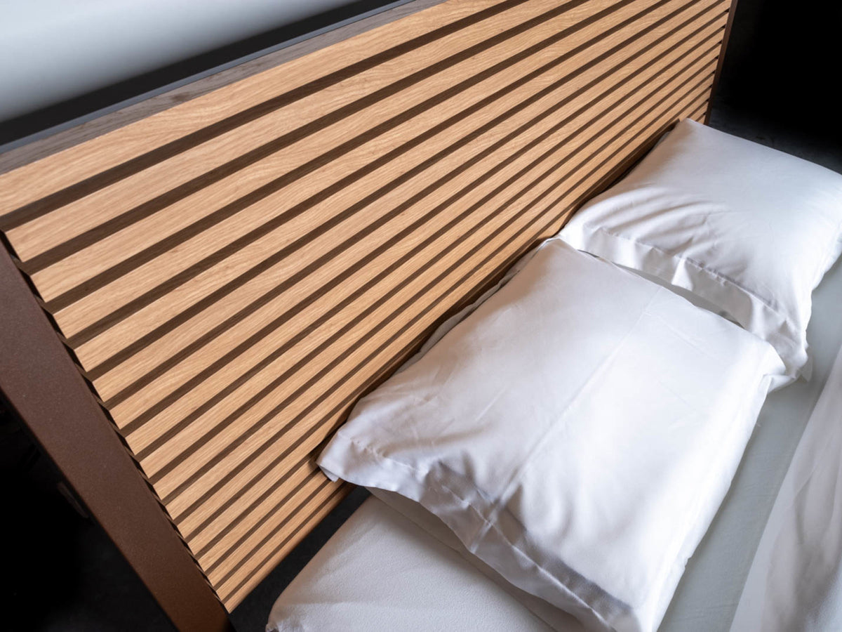 Top view of the wooden slats of The Loft canopy bed with headboard, with two white pillows