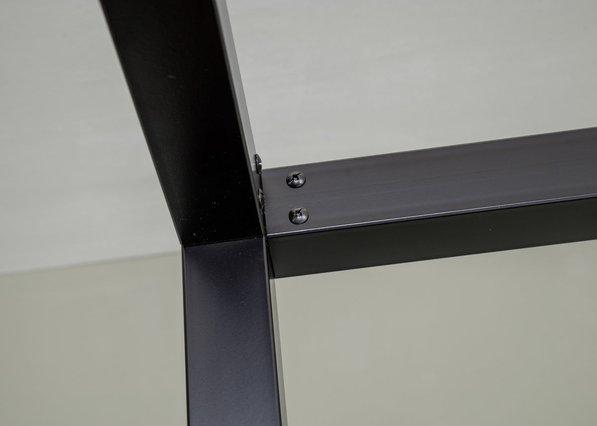 Close-up of a black corner joint with screws of The Loft canopy bed without headboard