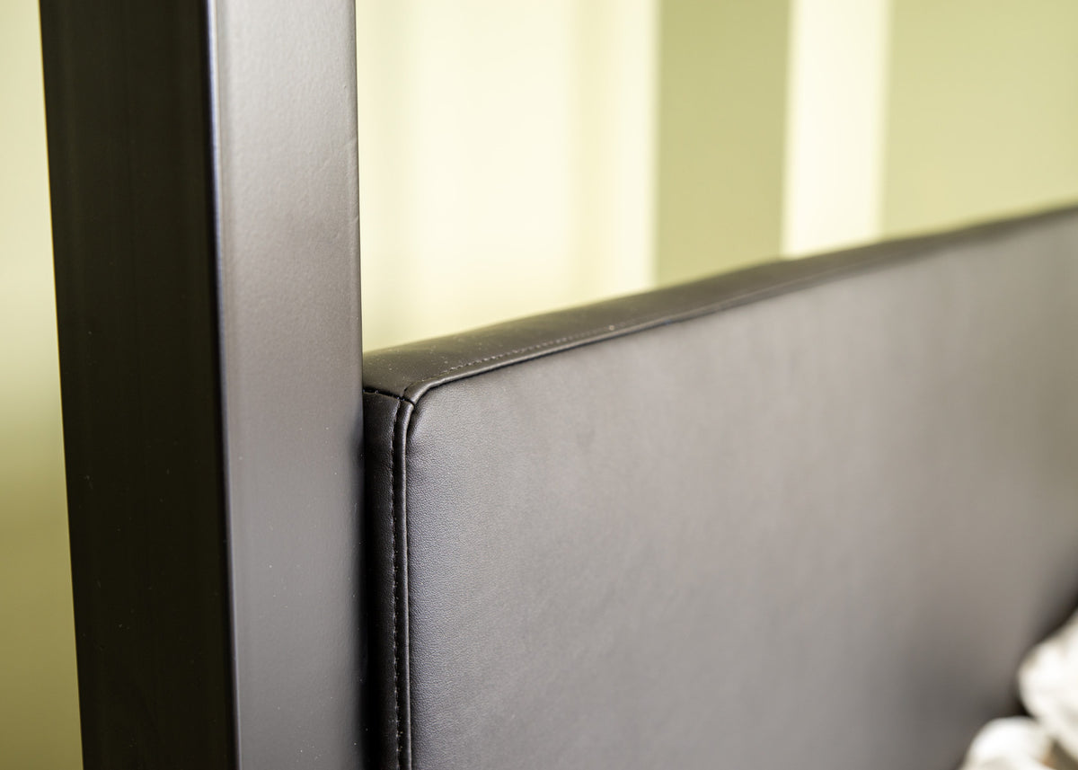 Close-up of the stitched seam along the upholstered head end of The Loft canopy bed with headboard