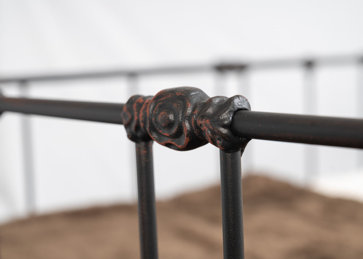 Detail of a decorative knot between rail and spindle of the Veurne metal single bed in dark patina