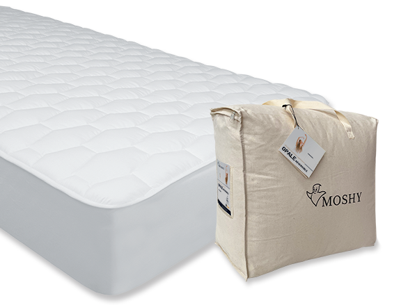 Opale mattress protector in white with a quilted top, around a mattress next to the storage bag