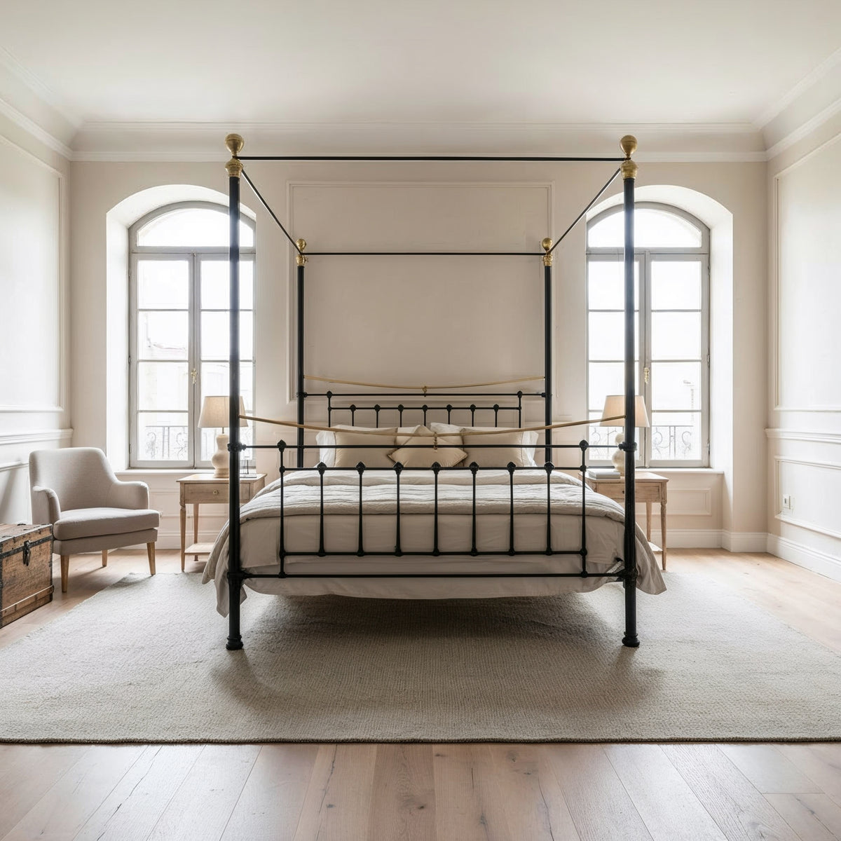 Front view of the Durham canopy bed showroom model 180x200cm in black with brass details, in front of two tall windows