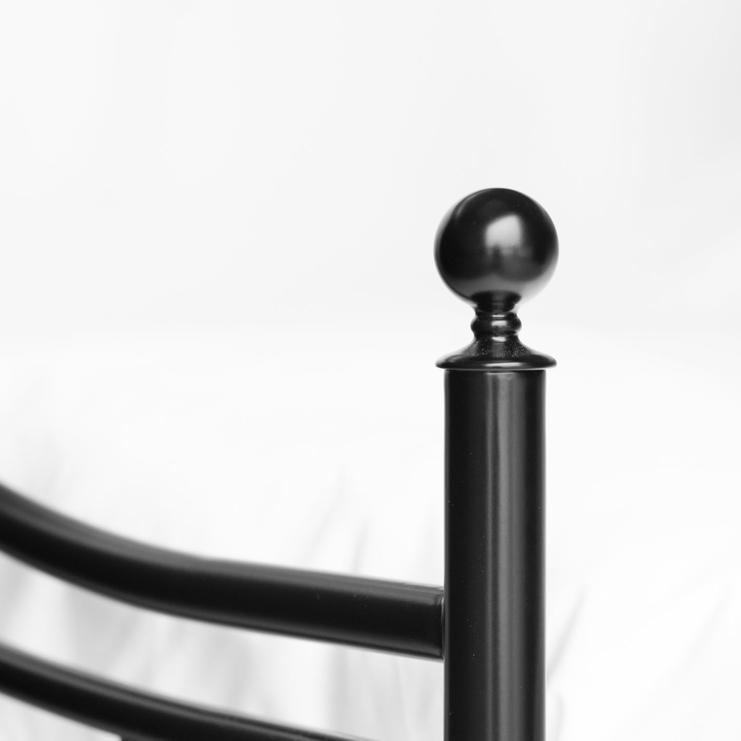 Detail decorative black decorative knob on corner post metal bed Beaumont