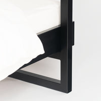 Corner joint of black metal bed frame Genk with characteristic straight lines