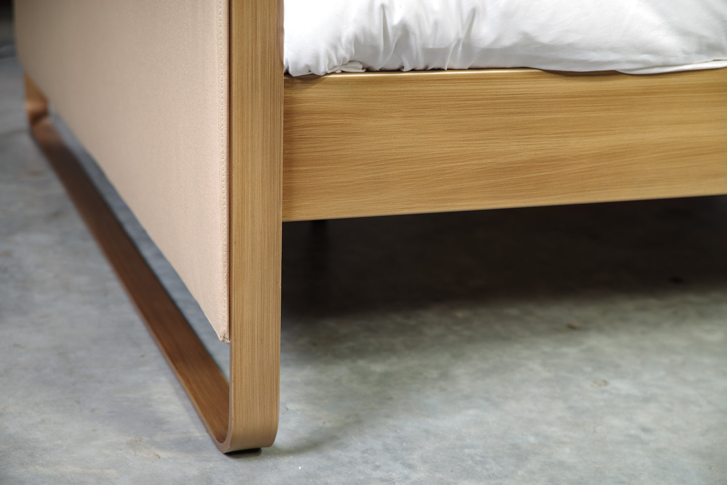 Corner joint of metal frame and beige textile of bed Milano