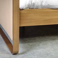 Corner joint of metal frame and beige textile of bed Milano