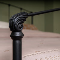 Black cast iron decorative element of bed Stavelot with traditional spiral details