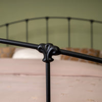 Close-up decorative connecting button of metal bed Stavelot with black matte finish