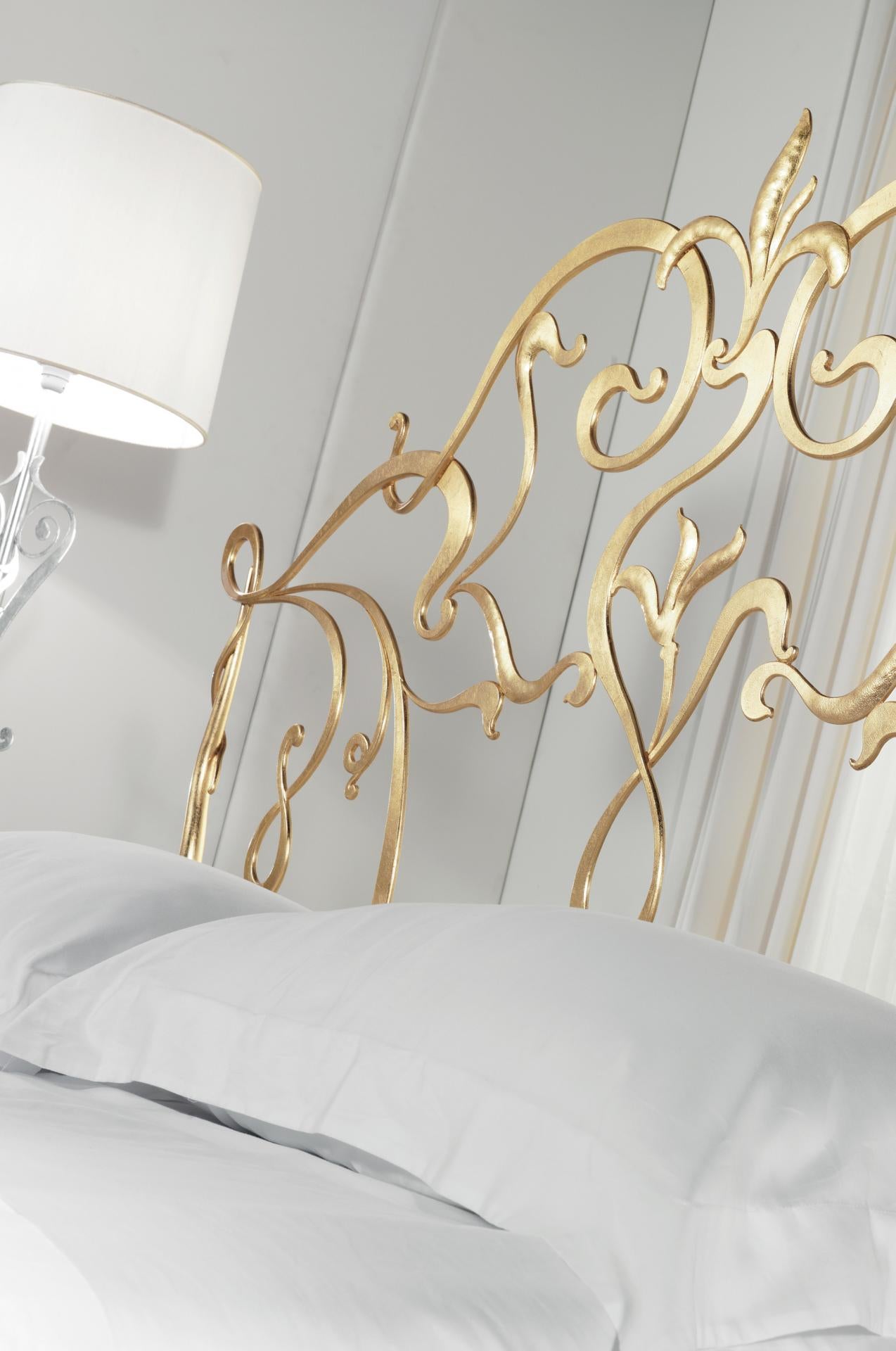 Close-up gold ornate headboard metal bed Valonge,