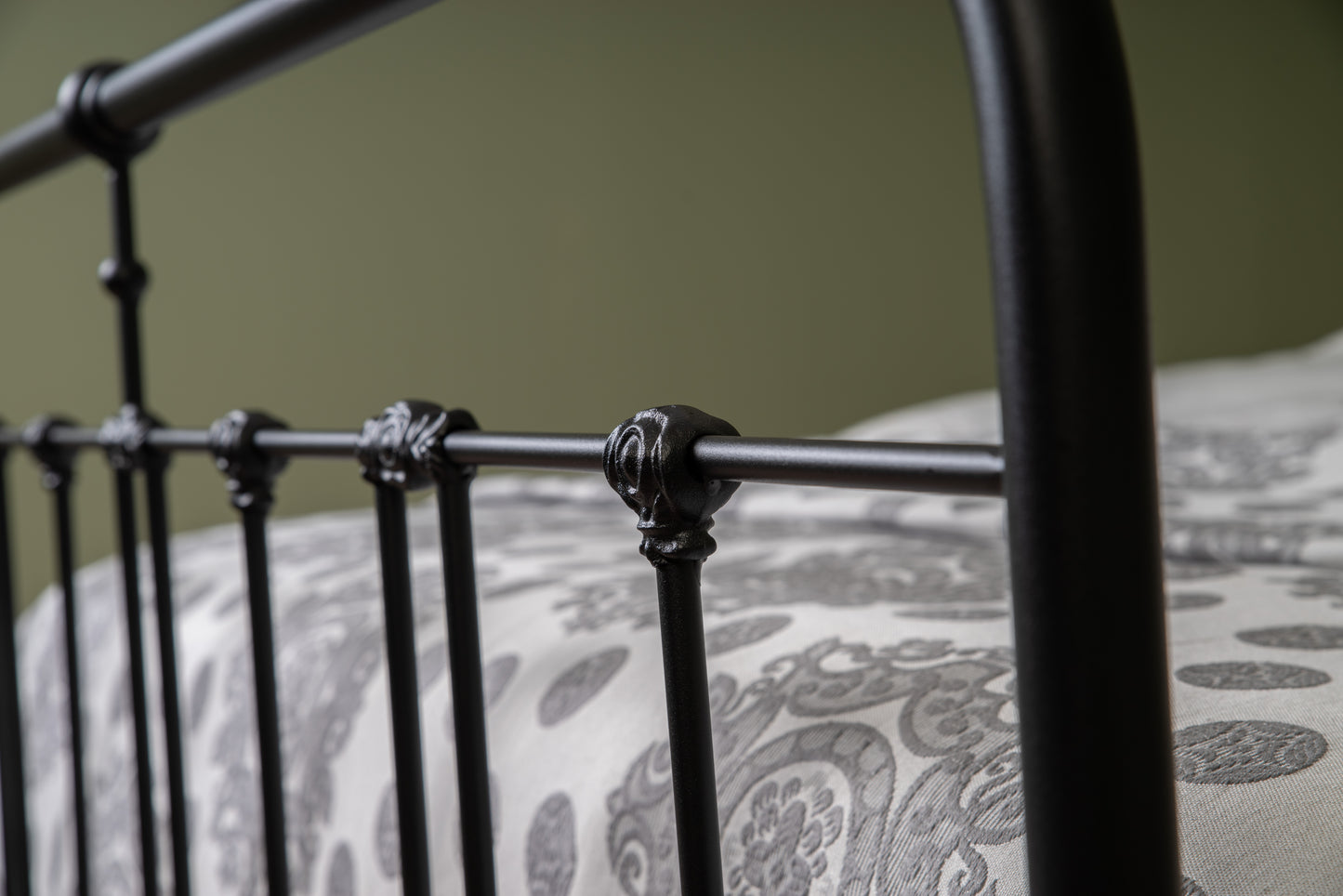 Close-up of decorative connecting node in matte black metal feed end bed Veurne