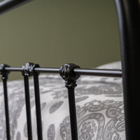 Close-up of decorative connecting node in matte black metal feed end bed Veurne