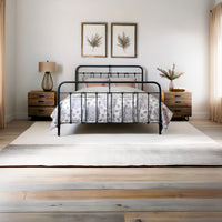 Front view classic metal bed Veurne in matte black with decorative bars and decorative headboard in country bedroom