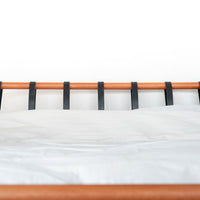 Full headboard metal bed Cudillero with black strips and warm wooden tube